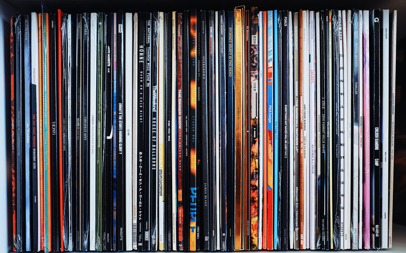 Vinyl Records all stacked next to each other.